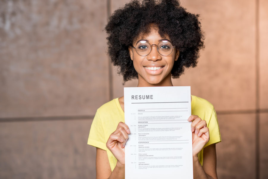 Woman with glasses holding resume